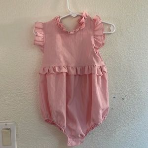 Pink romper with no tags.